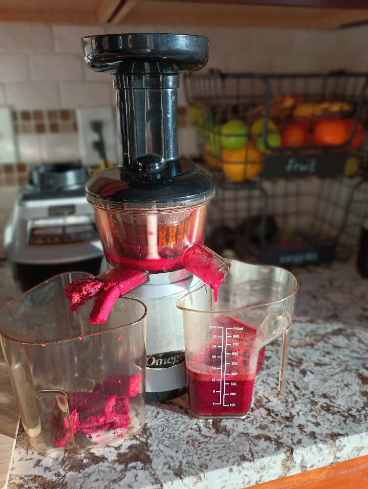 Beet Juice being made in a masticating juicer